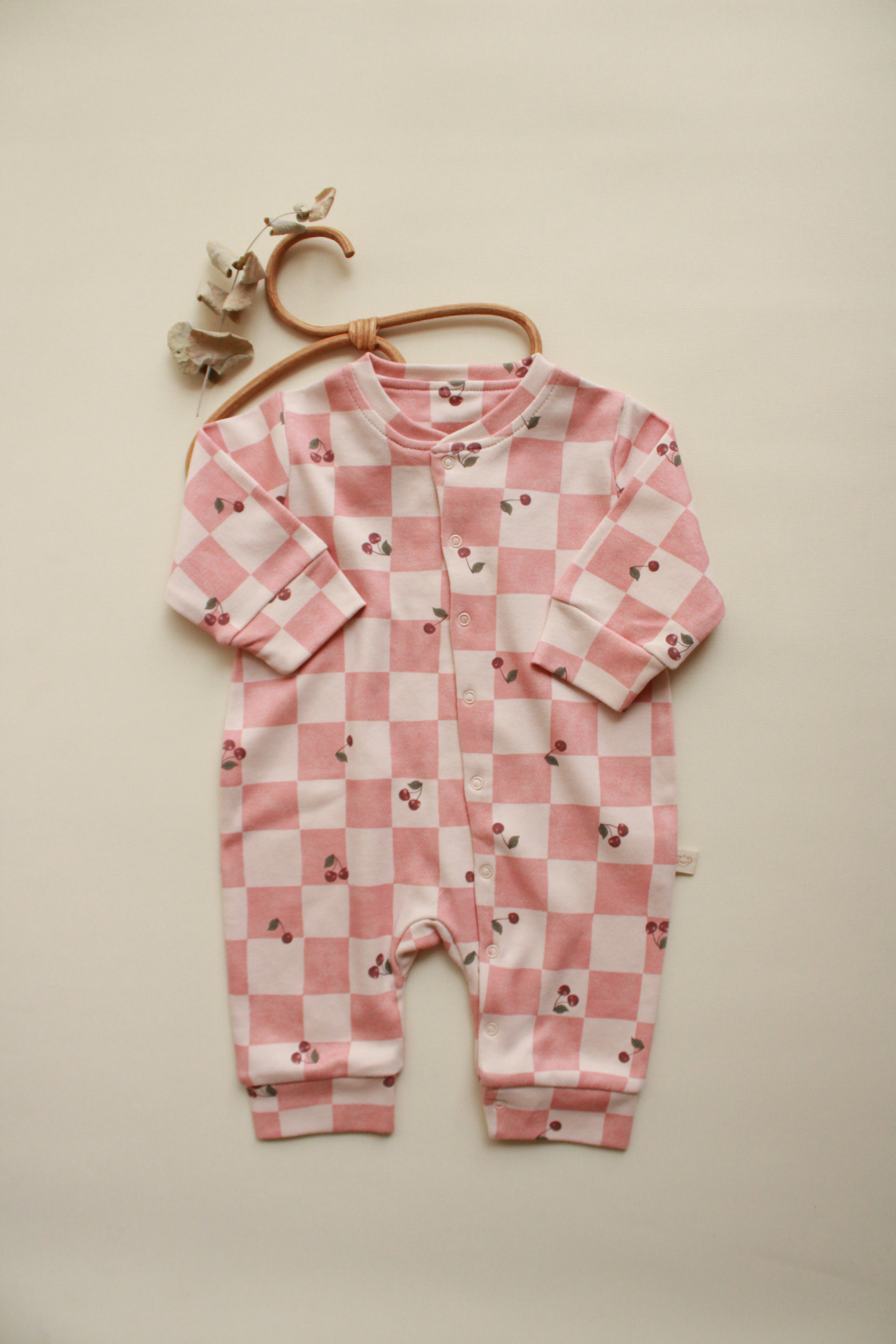 Cherry plaid baby onesie with pink check pattern