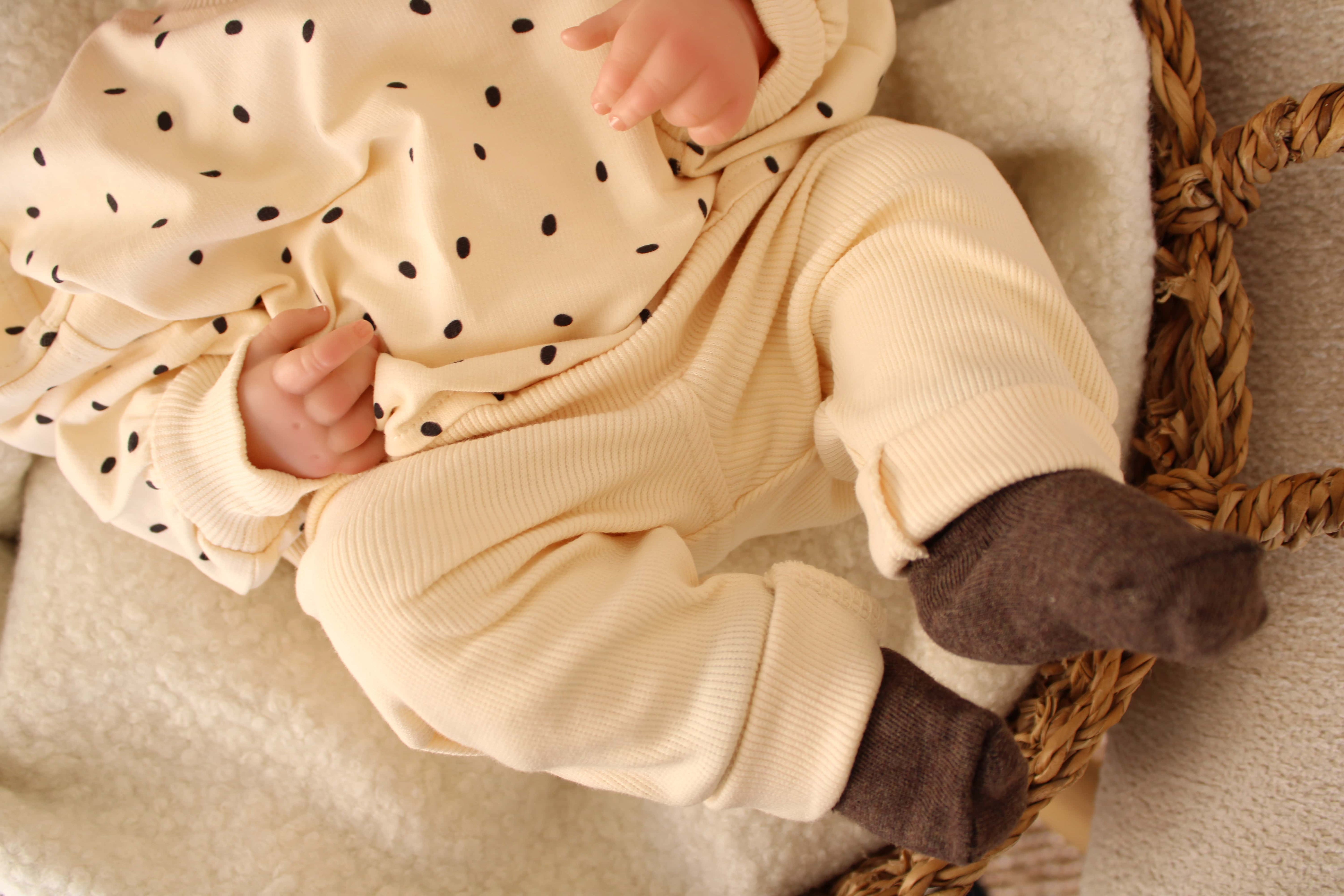 Comfy baby outfit in cream with tiny black dots and matching pants.