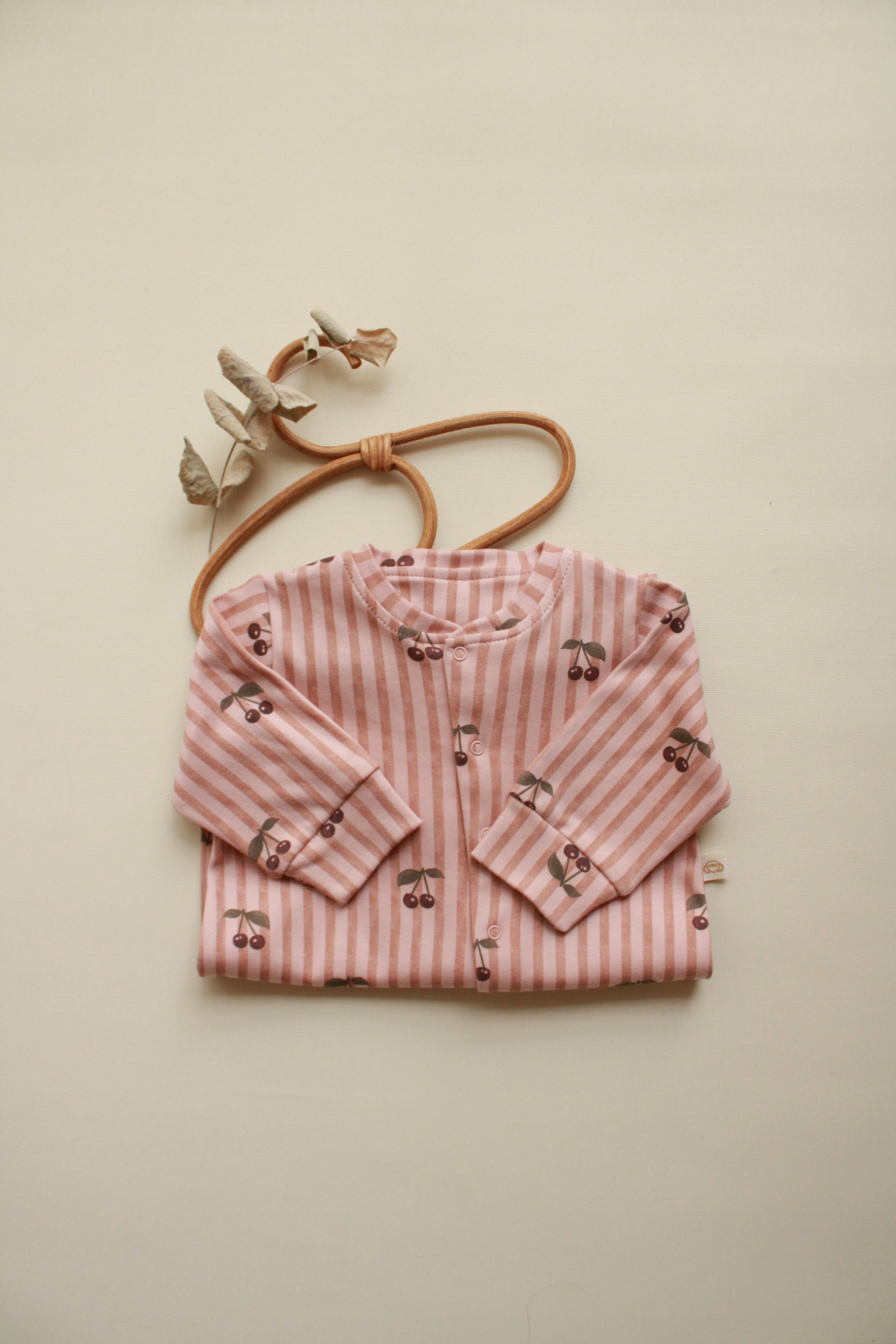 Soft cotton striped baby onesie with snap button closure