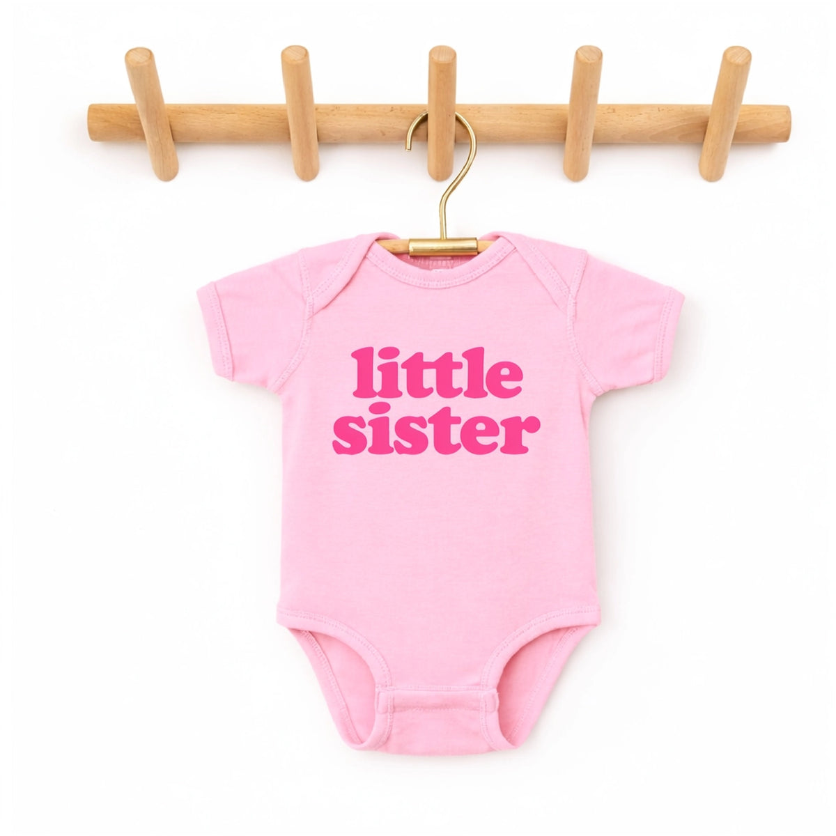 pink baby bodysuit featuring Little sister graphic in pink lettering