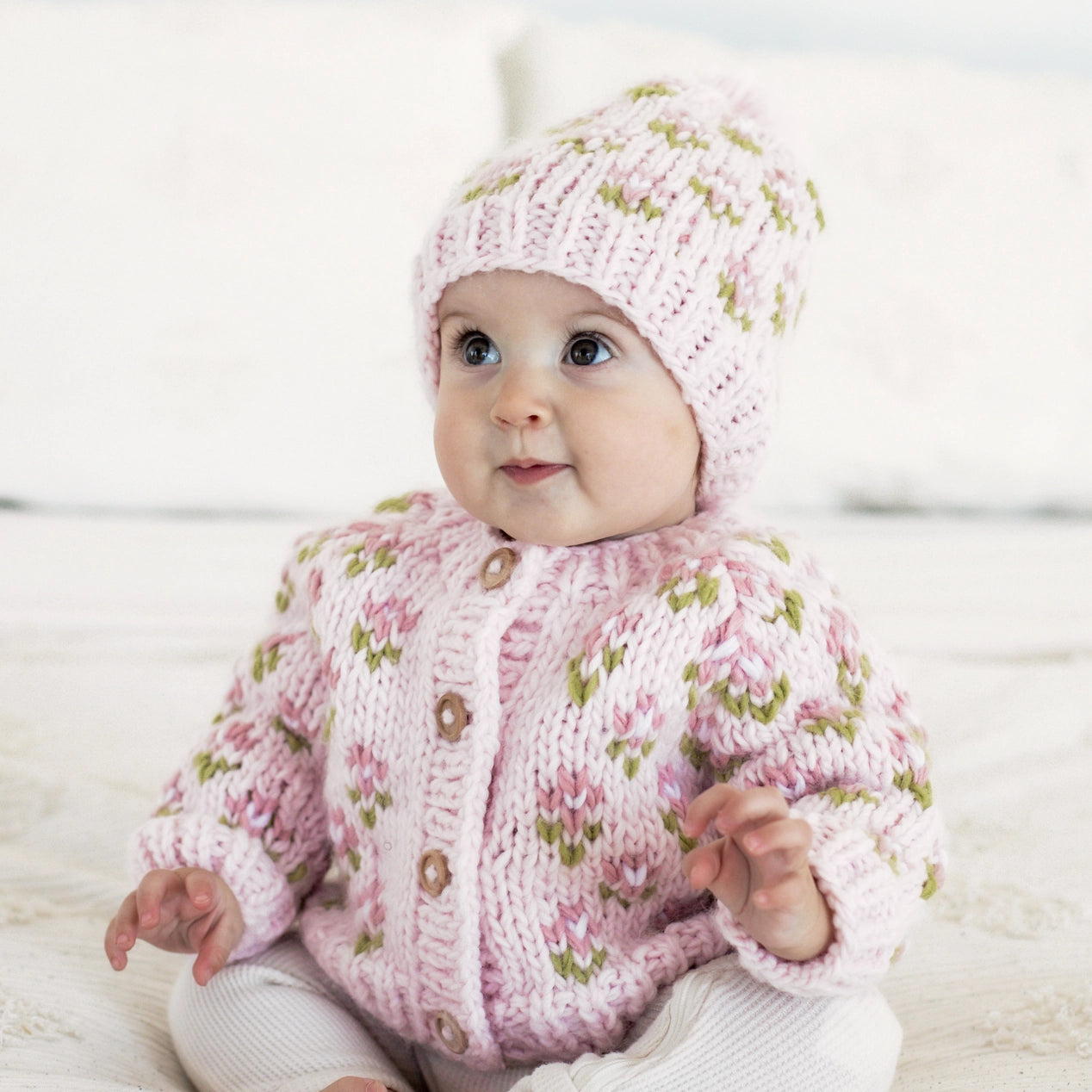 Handmade knitted baby cardigan, breathable cotton outerwear designed for newborn comfort.