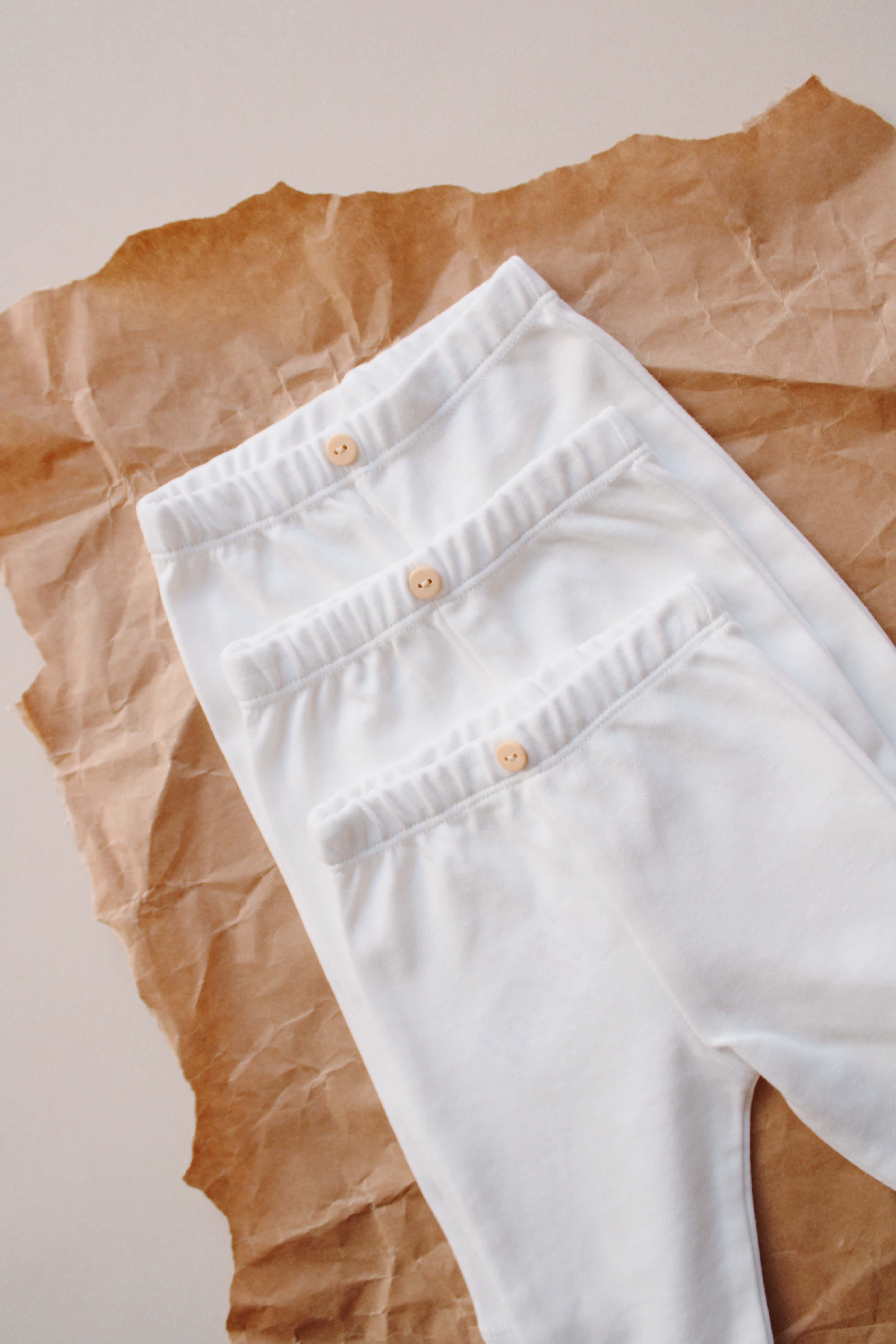 White baby pants 3 piece set, lightweight cotton clothing essentials for newborn comfort.