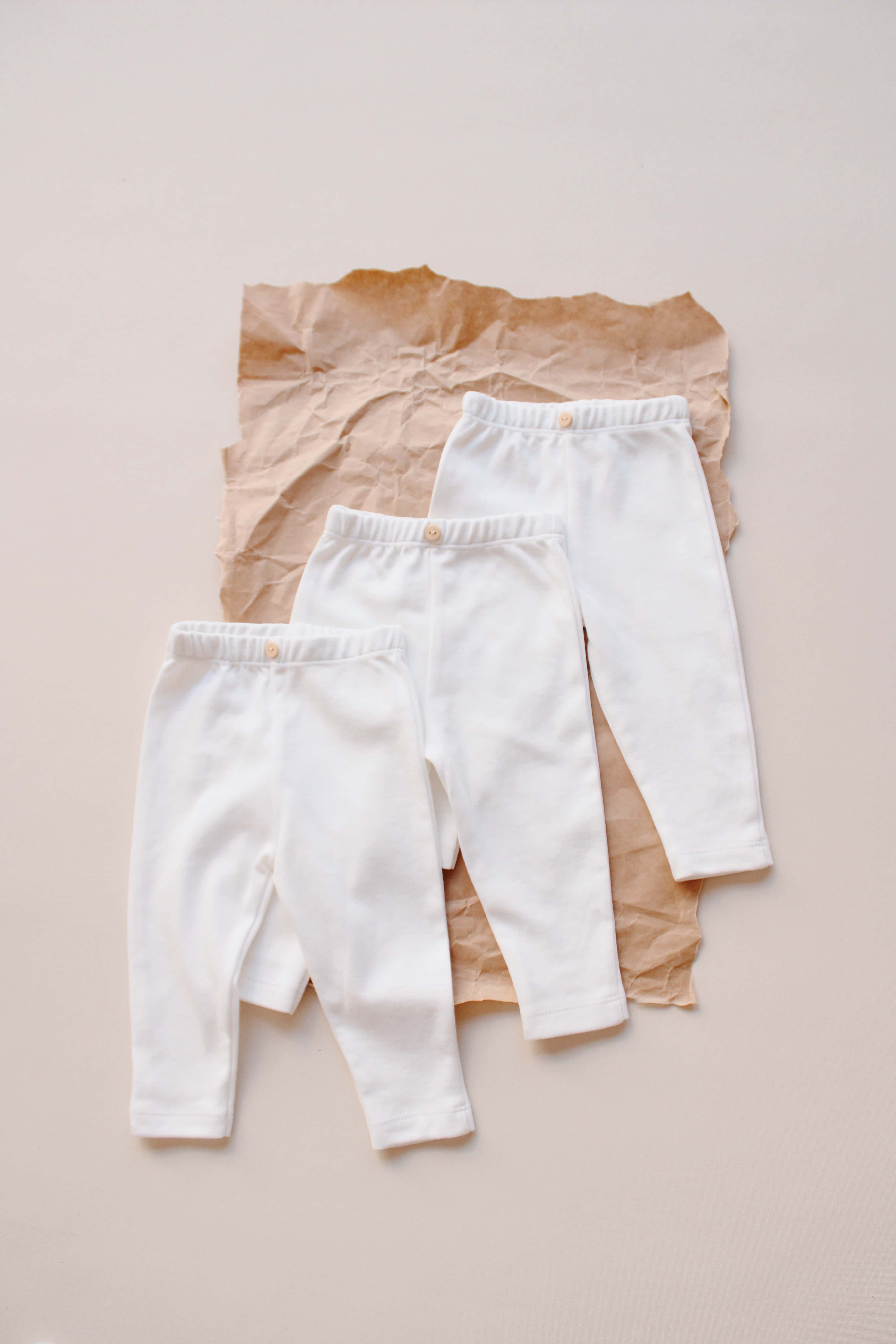 Unisex 3 piece white pants set, soft organic cotton outfit for infants and toddlers.