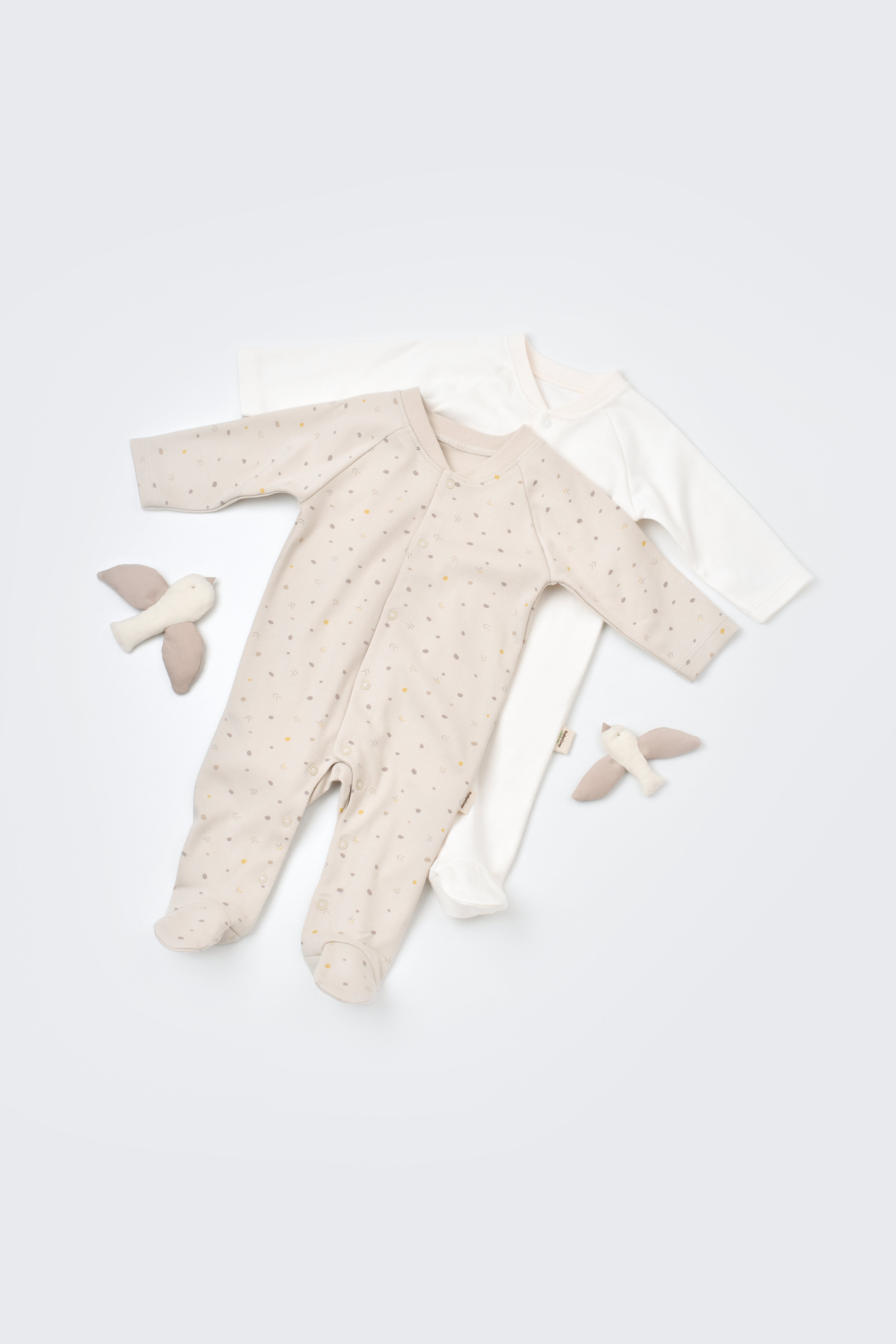 Two baby onesies made from 100% organic cotton, cozy unisex clothing for newborns.